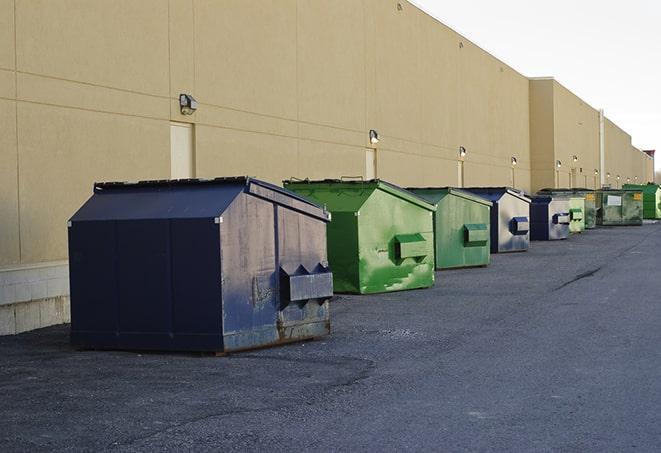 construction dumpsters on a worksite surrounded by caution tape in Afton